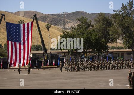 U.S. Marines with 2nd Battalion, 11th Marine Regiment, 1st Marine Division, march into position during a change of command ceremony at Marine Corps Base Camp Pendleton, Calif., June 26, 2018. The change of command ceremony represented the official passing of authority from the offgoing commander, Lt. Col Patrick F. Eldridge, to the incoming commander, Lt. Col. Caleb Hyatt. Stock Photo