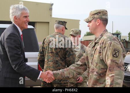 1st Sgt. Matthew Lally, Task Force Darby, 1st Battalion, 32nd Infantry Regiment, 10th Mountain Division security force soldier, shakes hands with Ambassador Peter Henry Barlerin, the U.S. Ambassador to the Republic of Cameroon (in suit) while Capt. Aaron Zakarison, TF Darby security forces commander, shakes hands with General Thomas David Waldhauser of the United States Marine Corps and commander of United States Africa Command at the close of the Ambassador and General’s visit to Contingency Location Garoua June 28. Stock Photo