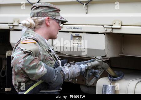 Pvt. Kayla Day, a petroleum supply specialist with Company A, 237th Brigade Support Battalion, provides fuel to a Light Medium Tactical Vehicle (LMTV) during annual training June 24 at the Camp Grayling Joint Maneuver Training Center in Grayling, Mich. (Ohio Army National Guard Stock Photo