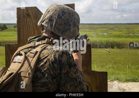 A Marine with Fox Company, Marine Combat Training Battalion (MCT), School of Infantry-East, fires a M16A4 Service Rifle during Table 3 and 4 marksmanship training, Camp Lejeune, N.C., June 27, 2018. MCT conducts standards-based common combat skills training of entry-level Marines in order to create riflemen for service throughout the Marine Corps. Stock Photo