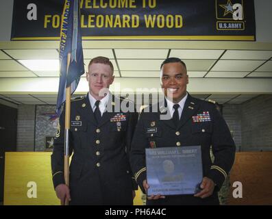 Army Reserve Capt. Lorenzo Llorente II (right), company commander, 342nd Chemical Company, 472nd Chemical Battalion, 209th Regional Support Group, 76th Operational Response Command, displays a Maj. Gen. William L. Sibert Award plaque at Fort Leonard Wood, Missouri June 28, after he and his company first sergeant Sgt. 1st Class John Baptisti (left) were presented the prestigious award at the Baker Theater during the 100th anniversary of the Chemical Corps.  This is the second year in a row the 342nd Chem. Co., has won the award which is presented to one company from each component of the Army t Stock Photo