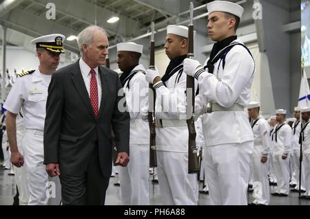 LAKES, Ill. (June 29, 2018) Secretary of the Navy Richard V. Spencer reviews the ceremonial honor guard at Midway Ceremonial Drill Hall during boot camp graduation at Recruit Training Command (RTC). Spencer served as the reviewing officer for the pass-in-review graduation ceremony where more than 650 recruits graduated from the Navy’s only boot camp. Spencer was making his second visit to RTC since being named secretary of the Navy on Aug. 3, 2017. About 38,000 to 40,000 recruits graduate annually from RTC. Stock Photo