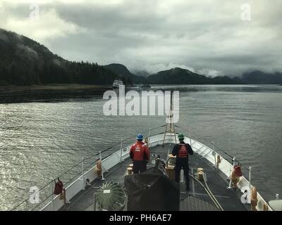 The crew aboard the Coast Guard Cutter Anacapa standby ready to assist the grounded cruise ship Alaskan Dream after it ran aground in Olga Strait, June 30, 2018. The Anacapa planned to remain on scene until after low tide to ensure the continued stability of the vessel and safety of the crew. Stock Photo