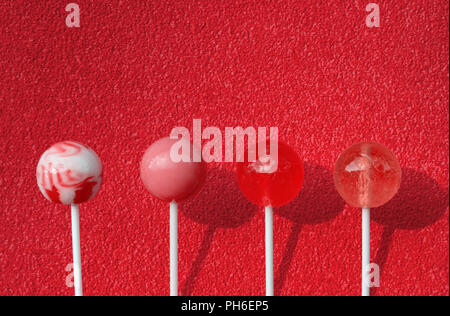 Lollipops on a red background. Copy space. Stock Photo
