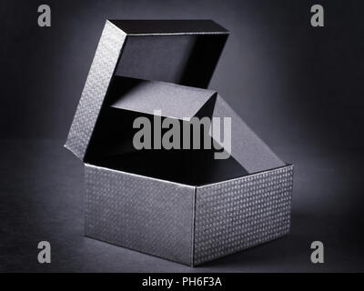 Open black box on black background. Stock Photo
