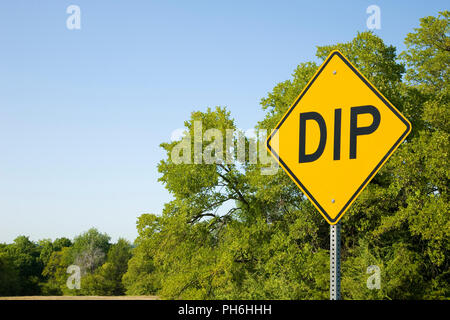 Dip Sign Against Green Trees and Blue Sky