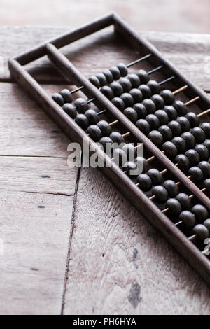 Old vintage abacus on wooden table Stock Photo