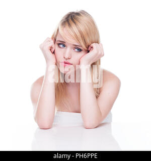 Unhappy Blond Woman with Head in Hands Stock Photo