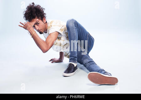 Male Dancer in a Hip Hop Pose on the Floor Stock Photo