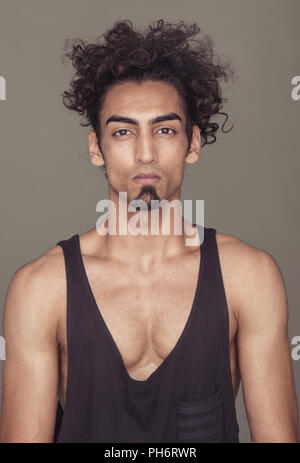 Gorgeous Fit Guy with Curly Hair Against Gray Stock Photo