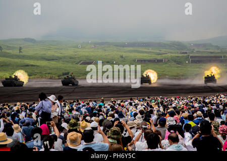 COMBINED ARMS TRAINING CENTER CAMP FUJI, GOTEMBA, Japan – Japan Ground Self-Defense Force Type-10 tank fires at long-range targets during the annual Fuji Firepower Demonstration Aug. 26 on Combined Arms Training Center Camp Fuji, Gotemba, Japan. The demonstration brought members of the local and U.S. communities together to observe and gain a better understanding of their capabilities in regards to the defense of Japan. Each year more of the public is educated, which in turn builds confidence in the precision, skill sets, and proficiency of the JGSDF. (U.S. Marine Corps photo by Pfc. Nicole Ro Stock Photo