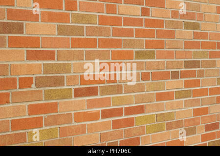 Flemish stretcher bond pattern vintage brick wall background with brick in multi color shades of orange, yellow and beige tan (angle view) Stock Photo