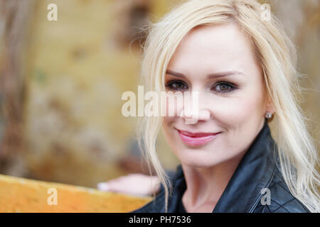Gorgeous Blond Woman Leaning on the Wall Stock Photo