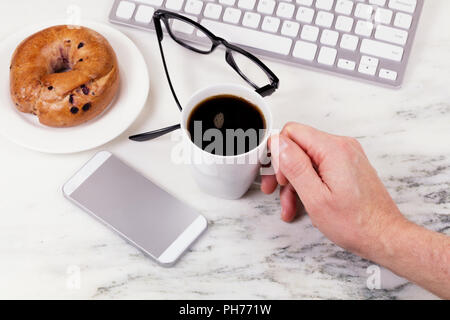 Morning coffee while working at home on white marble countertop Stock Photo