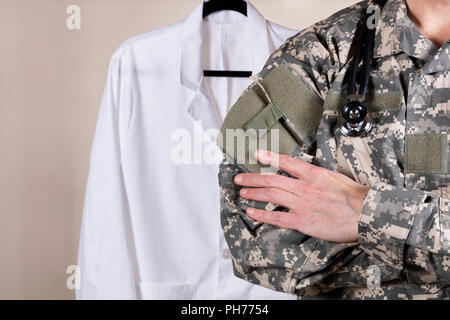 Medical military doctor with white consultation coat in background Stock Photo