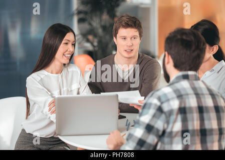Happy joyful people sharing their ideas Stock Photo