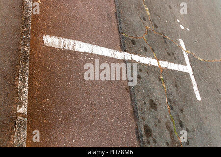 A white painted parking seperation marking showing where the parking starts and ends Stock Photo