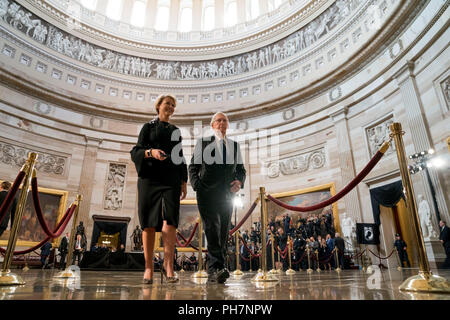 Senate Majority Leader Mitch McConnell of Ky., center, accompanied by an aide, walks through the Rotunda before the casket of Sen. John McCain, R-Ariz., lies in state at the U.S. Capitol, Friday, Aug. 31, 2018, in Washington. (AP Photo/Andrew Harnik, Pool) | usage worldwide Stock Photo