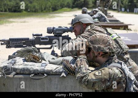 U.S. Army Reserve Soldiers assigned to Task Force Ultimate participate in crew-served weapon familiarization training during Operation Cold Steel II, in preparation for the arrival of troop list units, Fort Dix, N.J., June 30, 2018. Operation Cold Steel is the U.S. Army Reserve’s crew-served weapons qualification and validation exercise to ensure that America’s Army Reserve units and soldiers are trained and ready to deploy on short-notice and bring combat-ready and lethal firepower in support of the Army and our joint partners anywhere in the world. Stock Photo