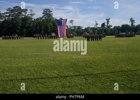 U.S. Marines with 2nd Transportation Support Battalion, Combat Logistics Regiment 2, 2nd Marine Logistics Group, attend a change of command ceremony on Camp Lejeune, N.C., June 28, 2018. During the ceremony, Lt. Col. John S. Sattely relinquished command of 2nd TSB to Lt. Col. Jonathan T. Baker. Stock Photo