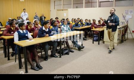 U.S. Military Academy mathematics professor Dr. Samuel Ivy lectures South African students to promote Science; Technology; Engineering and Math (STEM) education as part of the U.S. Africa Command outreach efforts with the African Institute for Mathematical Sciences in Muizenberg; South Africa; June 25; 2018. Ivy was joined by two West Point cadets to help facilitate learning and foster confidence in STEM for the African students. Stock Photo