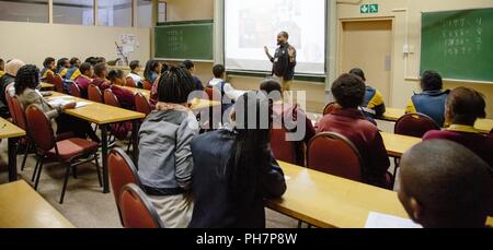 U.S. Military Academy mathematics professor Dr. Samuel Ivy lectures South African students to promote Science, Technology, Engineering and Math (STEM) education as part of the U.S. Africa Command outreach efforts with the African Institute for Mathematical Sciences in Muizenberg, South Africa, June 25, 2018. Ivy was joined by two West Point cadets to help facilitate learning and foster confidence in STEM for the African students. Stock Photo