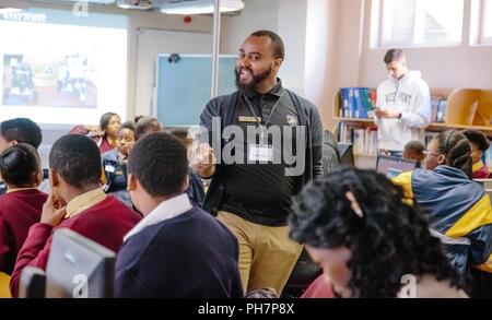 U.S. Military Academy mathematics professor Dr. Samuel Ivy lectures South African students to promote Science, Technology, Engineering and Math (STEM) education as part of the U.S. Africa Command outreach efforts with the African Institute for Mathematical Sciences in Muizenberg, South Africa, June 25, 2018. Ivy was joined by two West Point cadets to help facilitate learning and foster confidence in STEM for the African students. Stock Photo