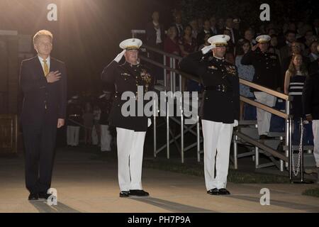 The official party for a Friday Evening Parade renders honors during the ceremony at Marine Barracks Washington D.C., June 29, 2018. The guest of honor for the ceremony was the Under Secretary of the Navy, Thomas B. Modly, and the hosting official was the Assistant Commandant of the Marine Corps, Gen. Glenn M. Walters. Stock Photo
