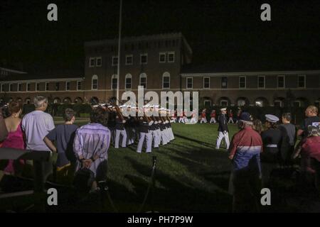 Marines from Marine Barracks Washington D.C. march off the parade deck during a Friday Evening Parade at the Barracks, June 29, 2018. The guest of honor for the ceremony was the Under Secretary of the Navy, Thomas B. Modly, and the hosting official was the Assistant Commandant of the Marine Corps, Gen. Glenn M. Walters. Stock Photo