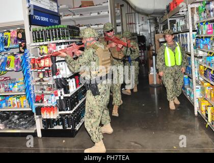 CAMP LEMONNIER, Djibouti – Members of Camp Lemonnier's security and emergency medical services respond to an active shooter exercise at the Navy Exchange on base, June 26, 2018. Active shooter training is held quarterly to prepare first responders for real-world situations. Stock Photo