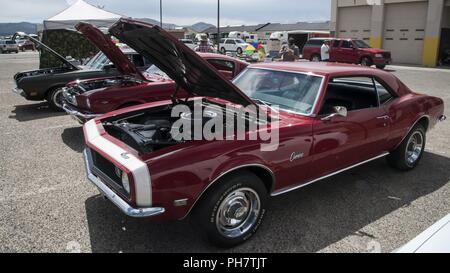 PHOTO DETAILS  /   DOWNLOAD HI-RES 8 of 8  From the 377th Force Support Squadron’s Gearheads Car Show June 30 at the Auto Hobby Shop: (Near to far) Wayne Descheneau's (Air Force Nuclear Weapons Center), shows his 1968 Chevy Camaro; his brother Troy Descheneau's 1965 Fastback Ford Mustang; and son Chase Descheneau's 1970 Mercury Cougar. Stock Photo