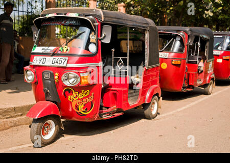 Line of parked 3 wheeler taxis along main road, Watamu, near Malindi ...