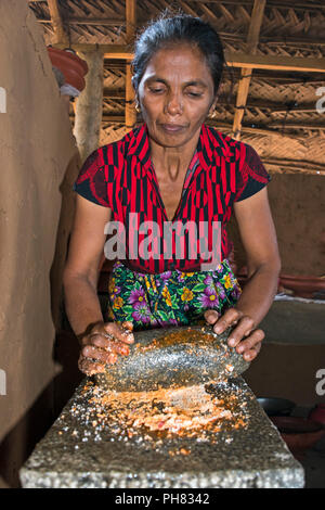 Vertical portrait of a lady cooking traditional Sri Lankan food. Stock Photo