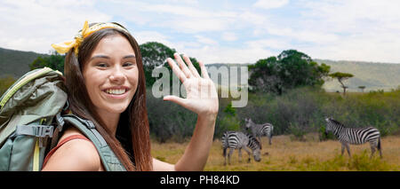 happy woman with backpack over savannah Stock Photo