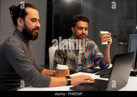 creative team drinking coffee at night office Stock Photo