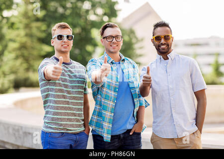 happy young men in sunglasses showing thumbs up Stock Photo