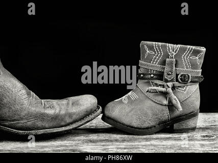 Daddy and baby cowboy with room for your type in black and white. Stock Photo