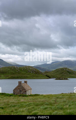 The old bothy on the shore of Loch Stack, Sutherland, Scotland. On an overcast day in summer. Stock Photo