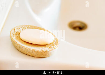Soap in a stylish dish over modern ceramic sink Stock Photo