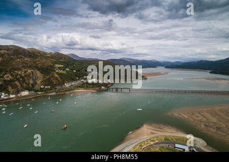 An aerial drone view of Barmouth (Y Bermo / Abermaw in welsh) - a small welsh town and seaside resort on the  mouth of the Mawddach  estuary, Gwynedd, Snowdonia National Park, North Wales UK (made by a CCA licenced and insured drone operator) Stock Photo