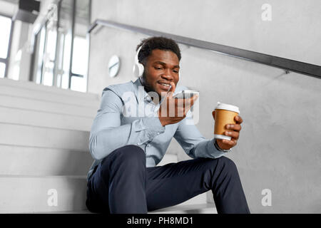 businessman records voice by smartphone at office Stock Photo