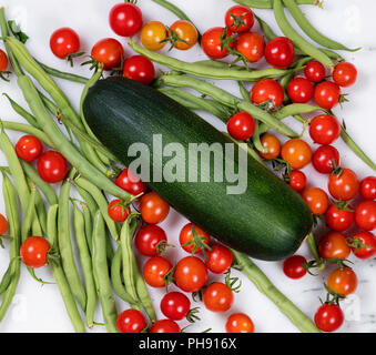 Freshly picked uncleaned vegetables on marble stone countertop Stock Photo