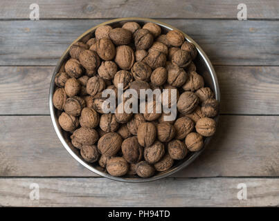 Walnuts in metal silver bowl Stock Photo