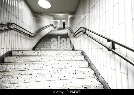 Person going up subway stairs Stock Photo