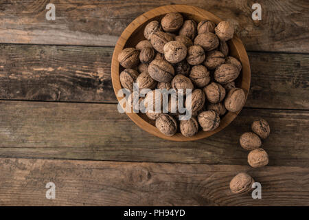 Walnuts in a wooden bowl Stock Photo