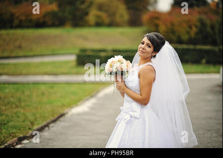 Portrait of bride with bouquet in autumn day Stock Photo