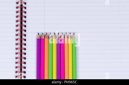 Lined up pencil tips on a spiral notebook background Stock Photo