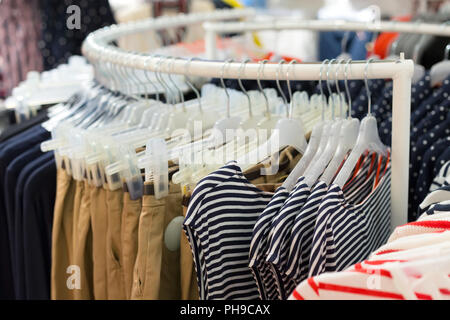 Clothes on hangers in store Stock Photo
