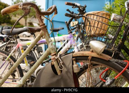 Nostalgic rusty bicycle locked for safety - close-up
