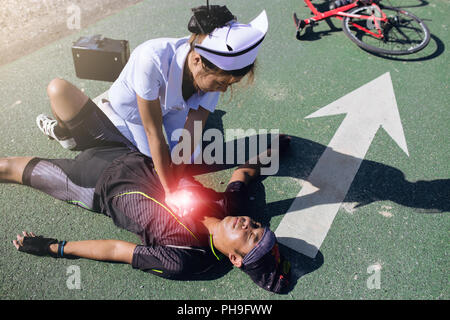 Female nurse helping Emergency CRP on bicycle man in an accident Stock ...